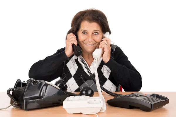 Senior woman with phones — Stock Photo, Image