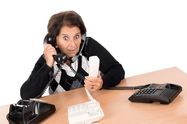 Starší žena s telefony — Stock fotografie