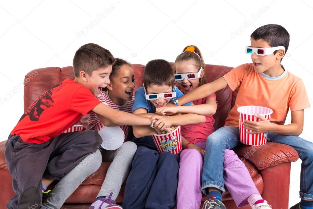 children watching movie with popcorn