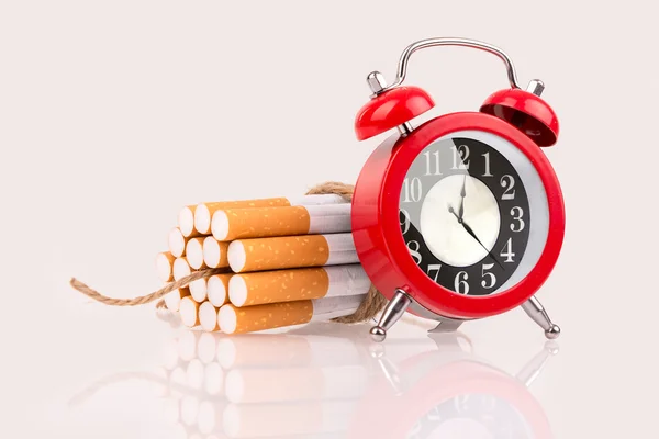 Alarm clock and cigarettes like bomb — Stock Photo, Image
