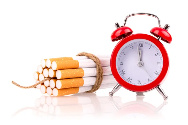 Alarm clock and cigarettes like bomb — Stock Photo, Image