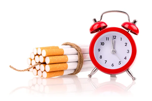 Alarm clock and cigarettes like bomb — Stock Photo, Image