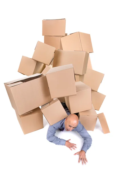 Businessman under boxes — Stock Photo, Image