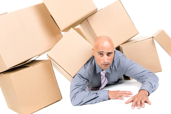 Businessman under boxes — Stock Photo, Image