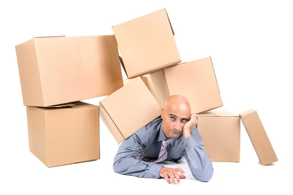 Businessman under boxes — Stock Photo, Image