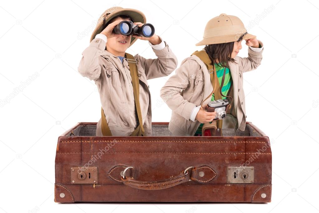 Two kids in suitcase on white