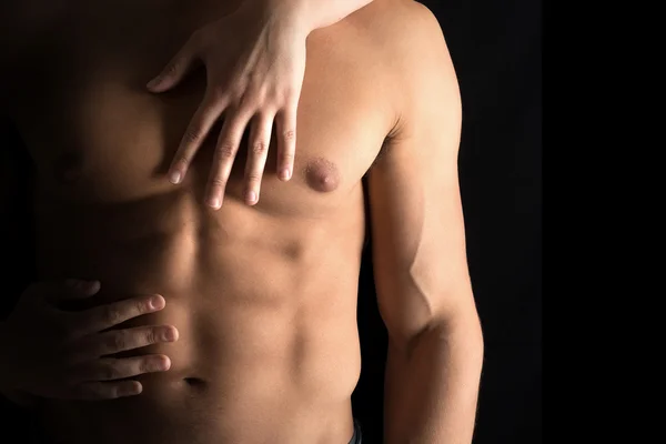 Man's torso with woman's hands — Stock Photo, Image