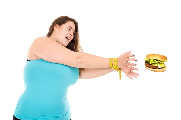 Large girl reaching for a burger — Stock Photo, Image