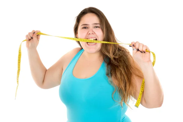 Menina grande mordendo uma fita métrica — Fotografia de Stock