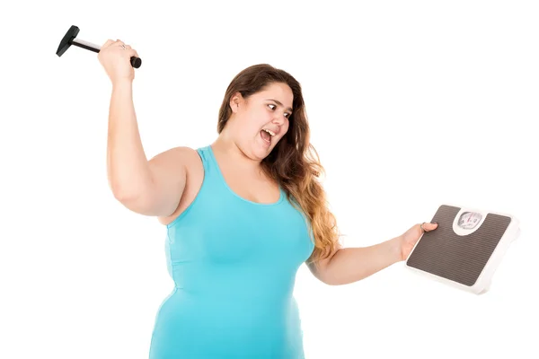 Large girl punishing a weight scale — Stock Photo, Image