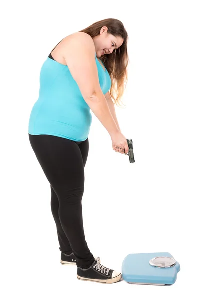 Large girl  weight scale with a gun — Stock Photo, Image
