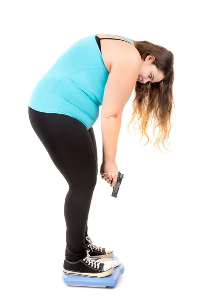 Large girl  weight scale with a gun — Stock Photo, Image