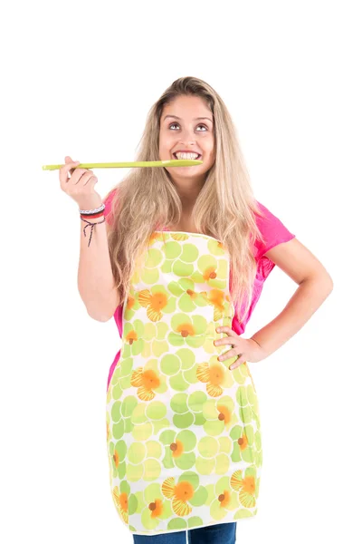 Woman with apron tasting food — Stock Photo, Image