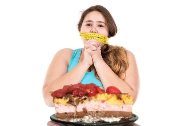 Large girl  looking at a cake clipart