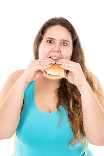 Large girl eating a burger — Stock Photo, Image