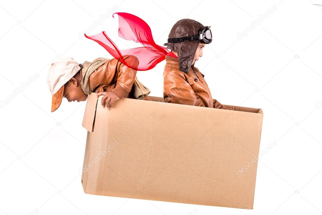Young boys playing in a cardboard box