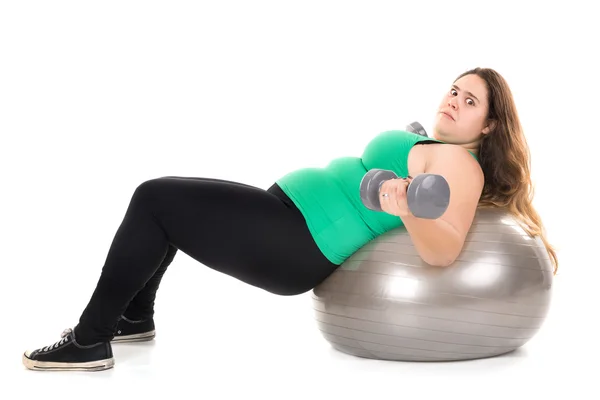 Large girl with fitness ball and dumbbells Stock Picture