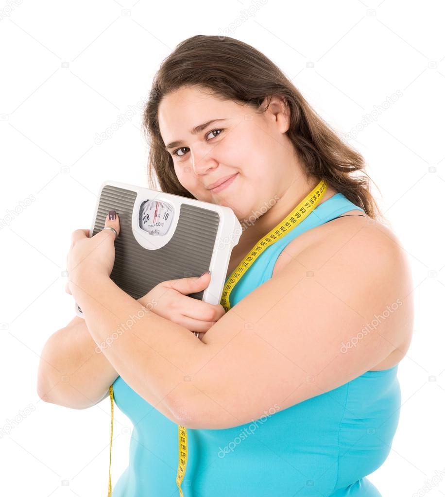 fat woman hugging measuring scale