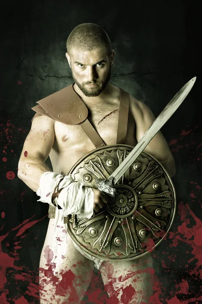 Gladiator posing with shield and sword — Stock Photo, Image