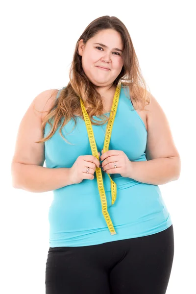 Толстая девушка с измерительной лентой — стоковое фото