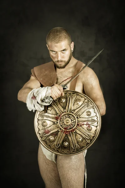 Gladiator posing with weapon — Stock Photo, Image