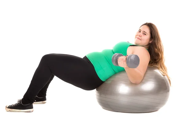 Large girl with fitness ball and dumbbells — Stock Photo, Image