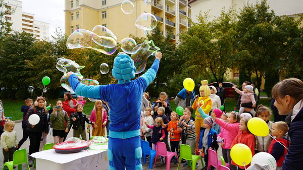 Kiev region, Chayki, Ukraine - November 2020: Children's show with animators. During the performance, animators entertain the children with soap bubbles.