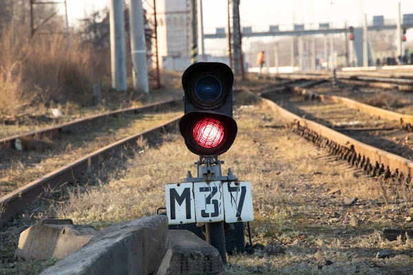 old railway traffic light with red light on on the railroad in the afternoon in Ukraine