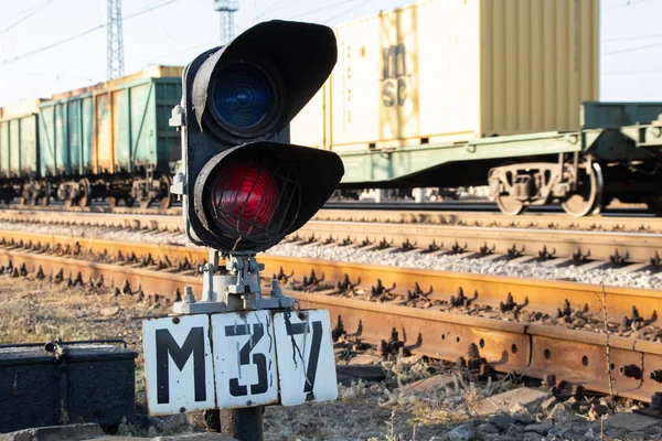 old railway traffic light with red light on on the railroad in the afternoon in Ukraine