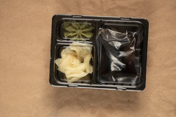 food container for delivery of sushi soy sauce and wasabi with food, delivery from sushi restaurant