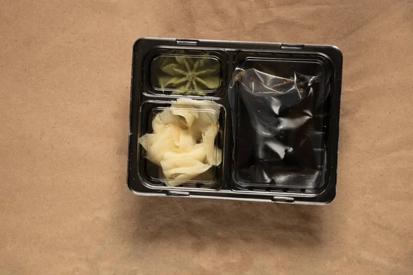 food container for delivery of sushi soy sauce and wasabi with food, delivery from sushi restaurant