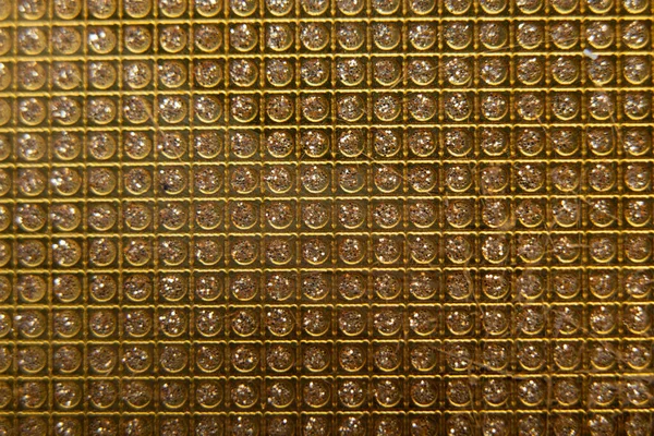 gold rhinestones as background in a row for design