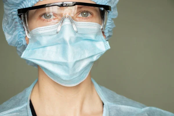 girl in a medical mask and glasses, medical worker overalls