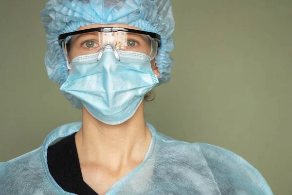 girl in a medical mask and glasses, medical worker overalls