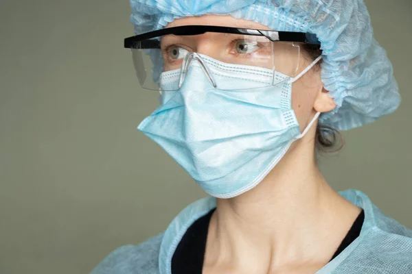 girl in a medical mask and glasses, medical worker overalls