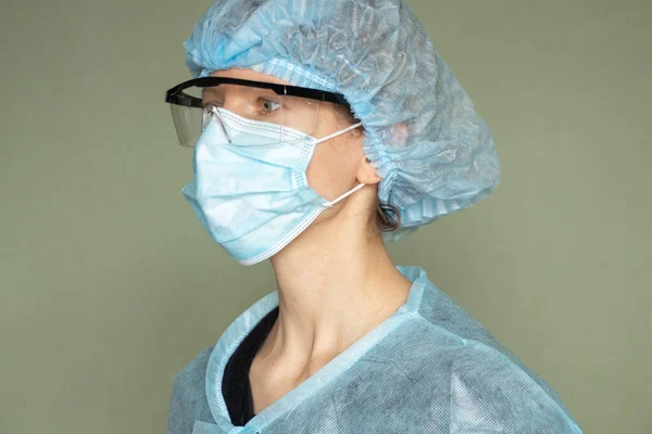 girl in a medical mask and glasses, medical worker overalls