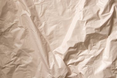 Tasarım için arkaplan olarak açık bej renkli buruşuk film