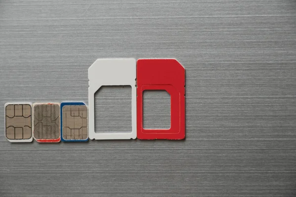 micro sim cards lie on a steel gray background close up