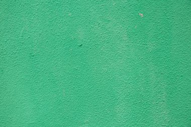 Arkaplan olarak bir evin yeşil kaba duvarı