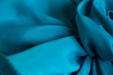 Tasarım için arkaplan olarak dalgalar halinde mavi ipek kırışık kumaş