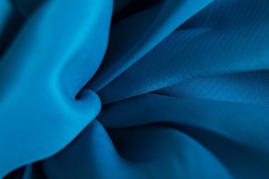 Tasarım için arkaplan olarak dalgalar halinde mavi ipek kırışık kumaş