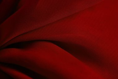 Tasarım için arkaplan olarak dalgalar halinde kırmızı ipekli kumaş