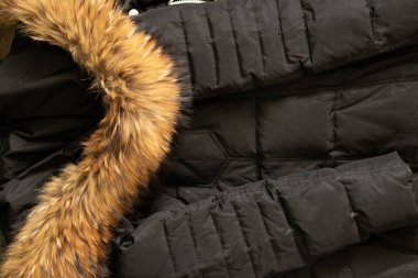 black women's down jacket with a fur collar on the hood as a background, winter clothing