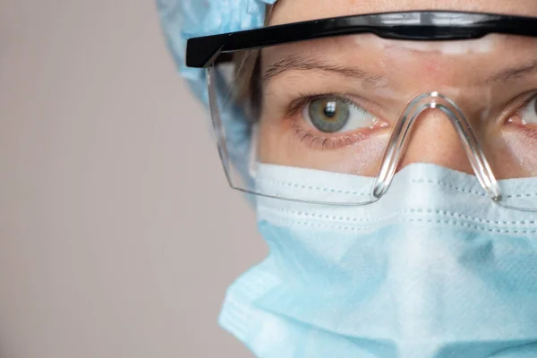 girl in a medical mask and glasses, medical worker overalls