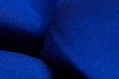 arka plan makro fotoğrafı olarak koyu mavi dalgalı kumaş