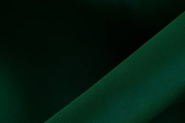 Arka plan makro fotoğrafı olarak koyu yeşil dalgalı kumaş