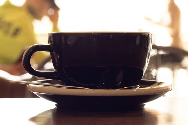 a cup of hot latte in the morning in a cafe for breakfast on the table