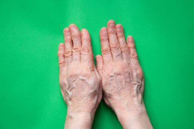 hands of an elderly woman close up on isolated background