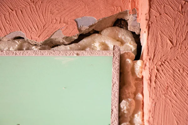 the wall is sheathed with moisture-resistant green plasterboard in the apartment, renovation work at home