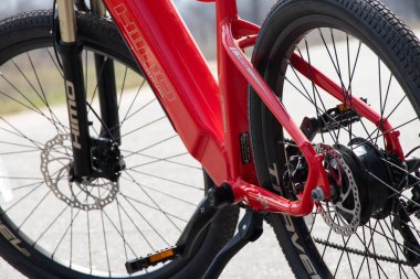 Ukraine Dnipro 05.04.2021 - a new red electric bike stands in a park in nature, new technologies